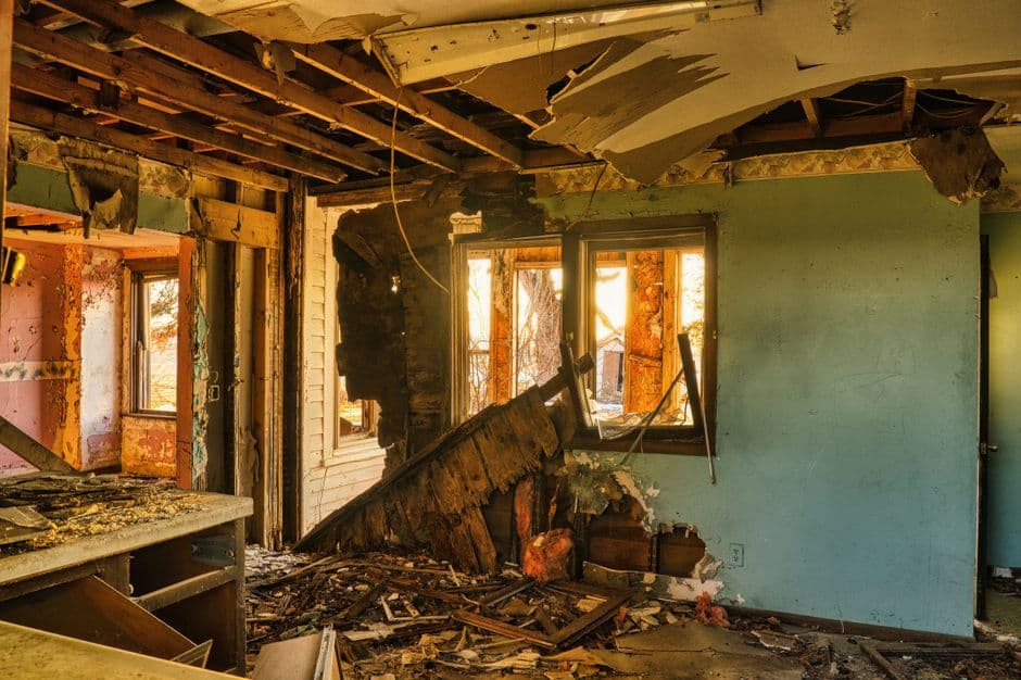 Water spreading across a floor from a burst pipe, saturating drywall and flooring within hours