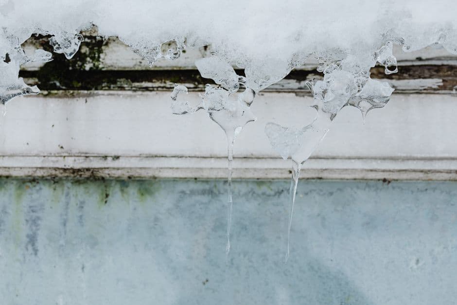 Frozen pipe in a Houston attic with ice crystals visible along a copper supply line